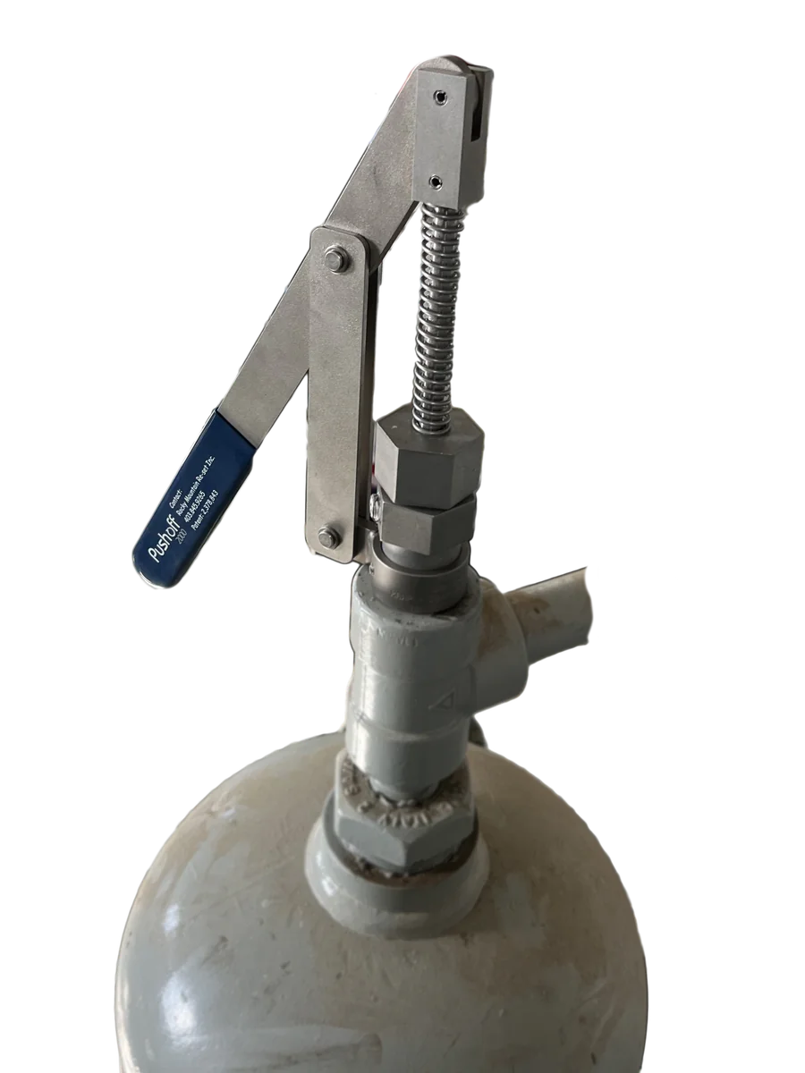 The Pushoff 2000 mounted on top of a fuel gas scrubber, with its blue-handled lever and spring-loaded plunger